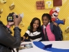 In this photo provided by Nintendo of America, Olympic gold medalist and longtime Super Mario Bros. fan Gabrielle Douglas meets her excited fan Hannah G., at Nintendo World in New York on Sept. 25, 2012. After wowing a worldwide audience in London, Douglas jumped at the chance to team up with Nintendo and promote New Super Mario Bros. 2 for the Nintendo 3DS hand-held system â her first major product endorsement since the Olympic games.