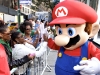 In this photo provided by Nintendo of America, Mario greets consumers waiting to meet Olympic gold medalist Gabrielle Douglas at Nintendo World in New York on Sept. 25, 2012. After wowing a worldwide audience in London, Douglas jumped at the chance to team up with Nintendo and promote New Super Mario Bros. 2 for the Nintendo 3DS hand-held system â her first major product endorsement since the Olympic games.