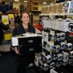 In this photo provided by Nintendo of America, Stephanie G., 22, of Burbank, Calif. makes an early-morning trip to the Best Buy Burbank, Calif., store to purchase a Wii during a Black Friday shopping trip on Nov. 25, 2011.Best Buy opened up its stores at 12:01 a.m. nationwide to give consumers a head start on holiday savings.(AP Photo/Nintendo, Bob Riha, Jr.) No Sales