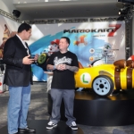In this photo provided by Nintendo of America, Reggie Fils-Aime, president and COO of Nintendo of America, and Ryan Friedlinghaus, founder and CEO of West Coast Customs, unveil two life-size Mario Kart-themed vehicles during a presentation at the LA Auto Show on Nov. 17, 2011. Nintendo teamed up with West Coast Customs to create the vehicles in celebration of the Dec. 4 release of Mario Kart 7 for the portable Nintendo 3DS system. (AP Photo/Nintendo, Bob Riha, Jr.) No Sales