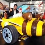 In this photo provided by Nintendo of America, Reggie Fils-Aime, president and COO of Nintendo of America gets behind the wheel of the Luigi Bumble V kart, one of two life-size Mario Kart-themed vehicles at the LA Auto Show, Nov. 17, 2011 in Los Angeles. Nintendo teamed up with West Coast Customs to create the vehicles in celebration of the Dec. 4 release of Mario Kart 7 for the portable Nintendo 3DS system. (AP Photo/Nintendo, Bob Riha, Jr.) No Sales