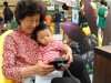 In this photo provided by Nintendo of America and released June 7, 2014, Ronghua W., 64, of China and her granddaughter Sophia X., 2, of Los Angeles, enjoy playing "Donkey Kong Country Returns 3D" at the Westfield Culver City mall on June 6, 2014. The free three-month ÒPlay Nintendo Tour 2014Ó kicked off in Los Angeles on June 6 and will visit malls and events in a dozen major cities across the United States, showcasing games that feature kid-friendly characters like Donkey Kong, Mario and Kirby, all played on Nintendo 2DS, the latest member of NintendoÕs hand-held family. (Photo by Nintendo/Bob
Riha, Jr.)